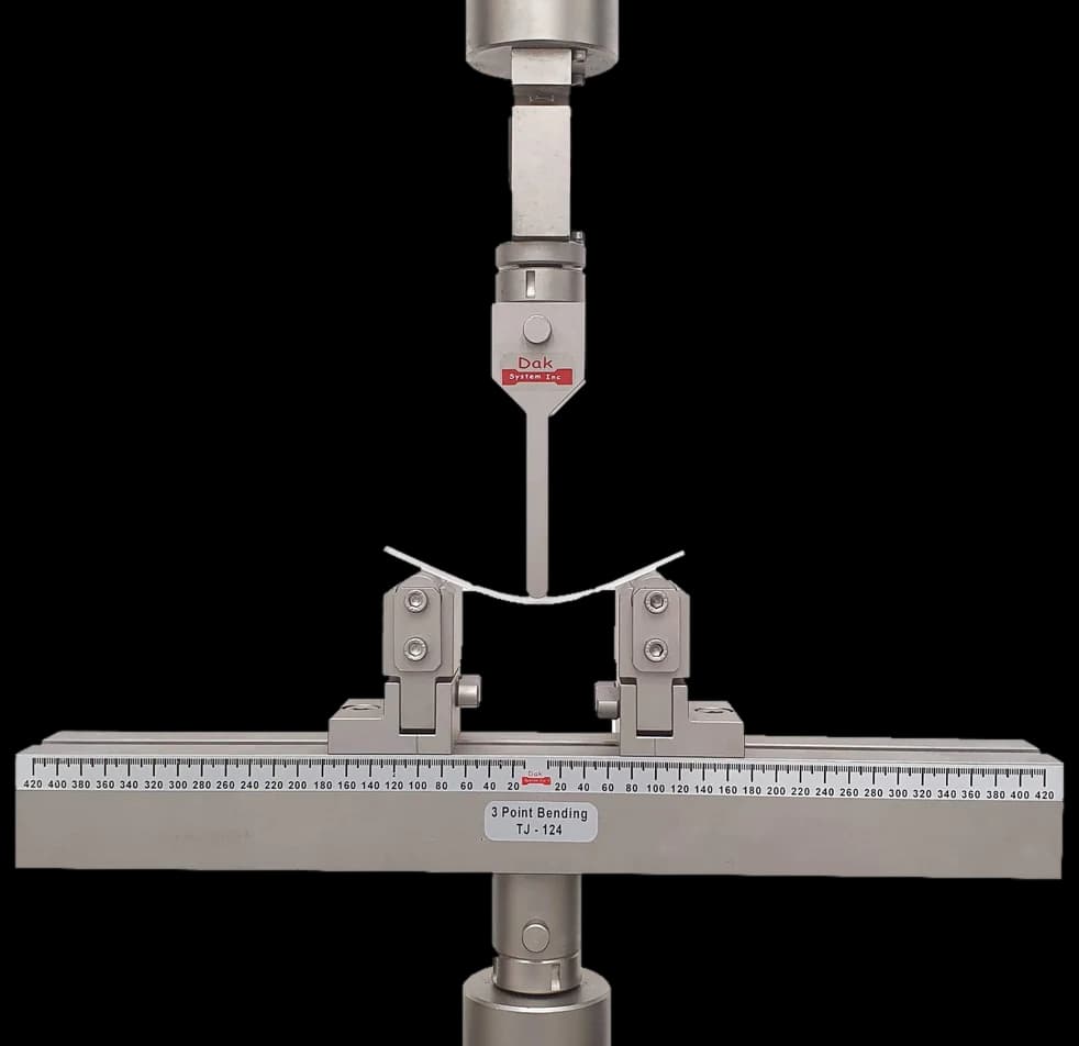Three point bending fixture with an adjustable span and a graduated beam
