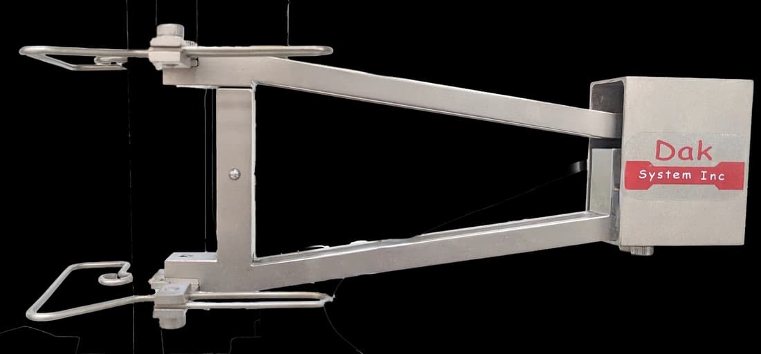 Clip-on cross-flexure extensometer on its mounting arm